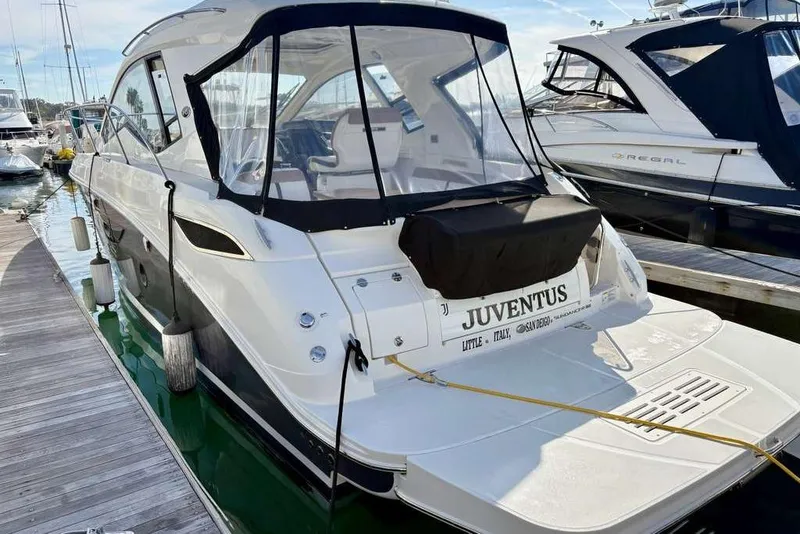 Slide: The Image of 2018 Sea Ray Sundancer 350 Coupe docked at marina, rear view with cover. - 3