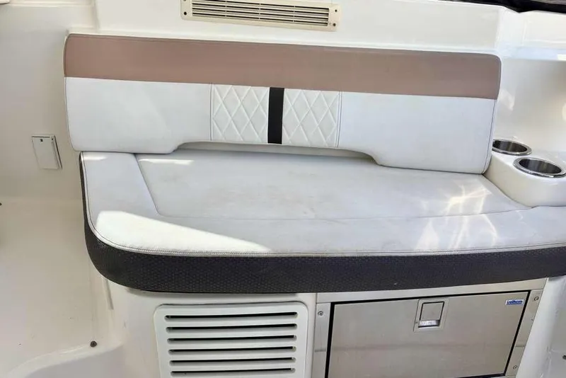 Slide: The Image of 2018 Sea Ray Sundancer 350 Coupe interior seating with cup holders and storage. - 8