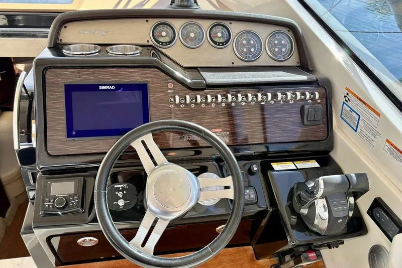 Slide: The Image of Helm of 2018 Sea Ray Sundancer 350 Coupe with navigation controls and gauges. - 9