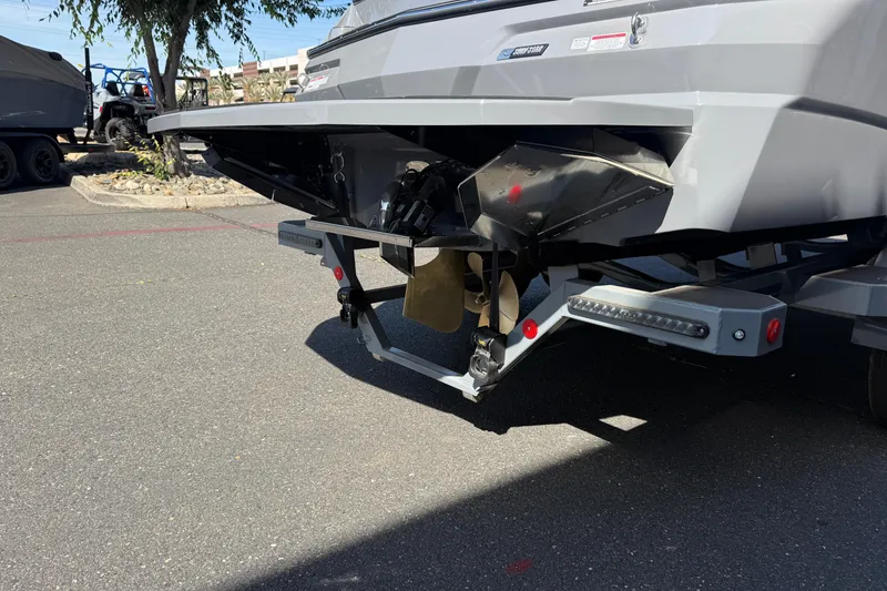 Slide: The Image of Rear view of 2026 MasterCraft NXT22 boat on trailer, showcasing propeller and hull design. - 12