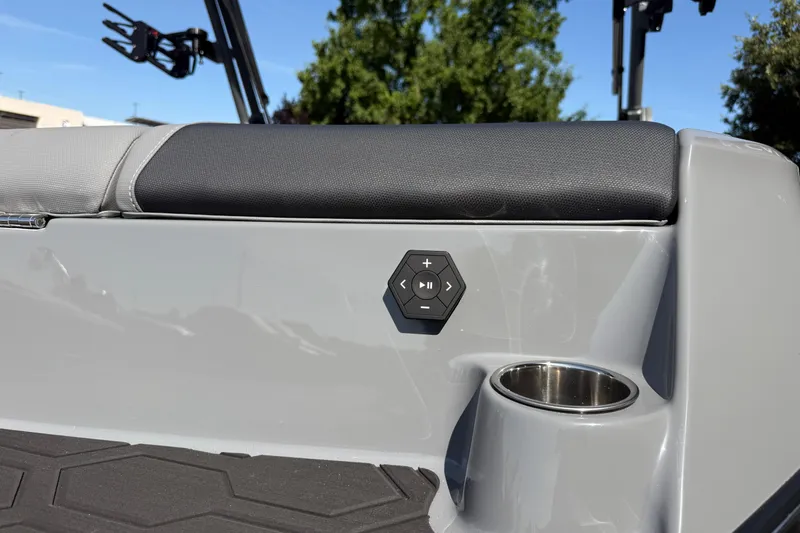 Slide: The Image of 2026 MasterCraft NXT22 boat interior with control panel and cup holder. - 13