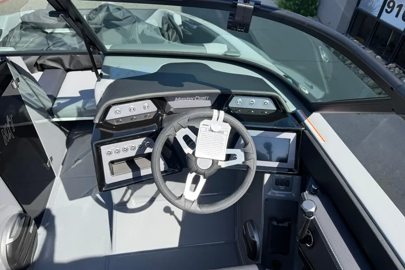 Slide: The Image of 2026 MasterCraft NXT22 boat dashboard with modern controls and steering wheel. - 14