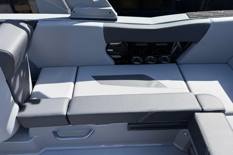 Slide: The Image of 2026 MasterCraft NXT22 boat interior with sleek gray seating and cup holders. - 16
