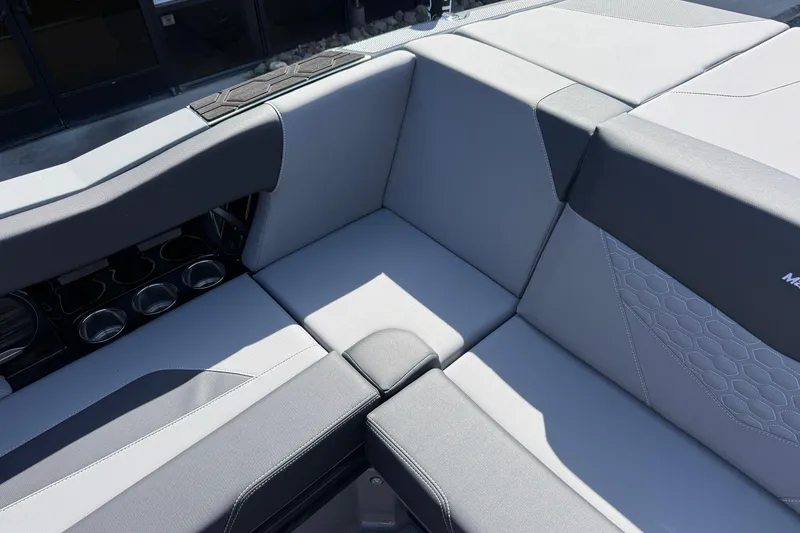 Slide: The Image of Luxurious seating on 2026 MasterCraft NXT22 boat with sleek gray upholstery and cup holders. - 17