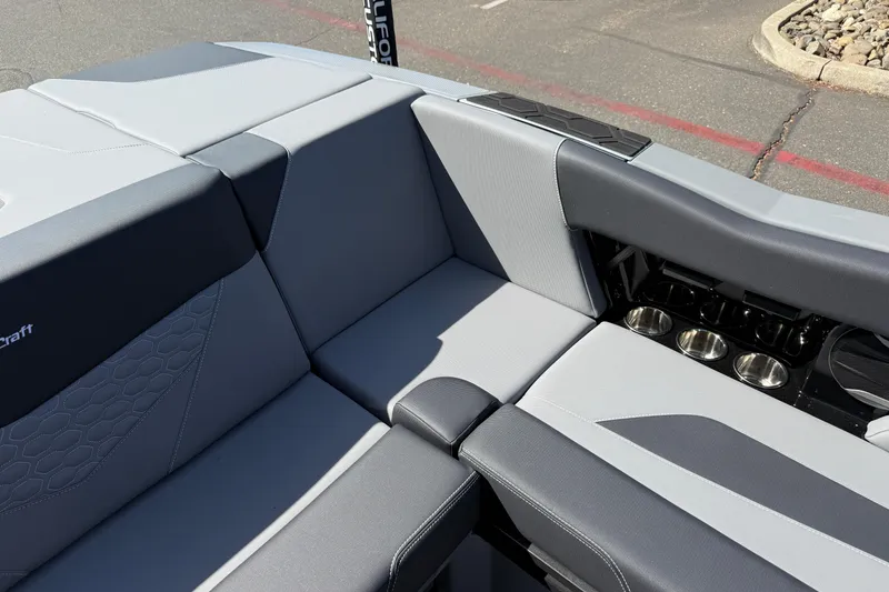 Slide: The Image of 2026 MasterCraft NXT22 boat interior with sleek gray seating and integrated cup holders. - 19