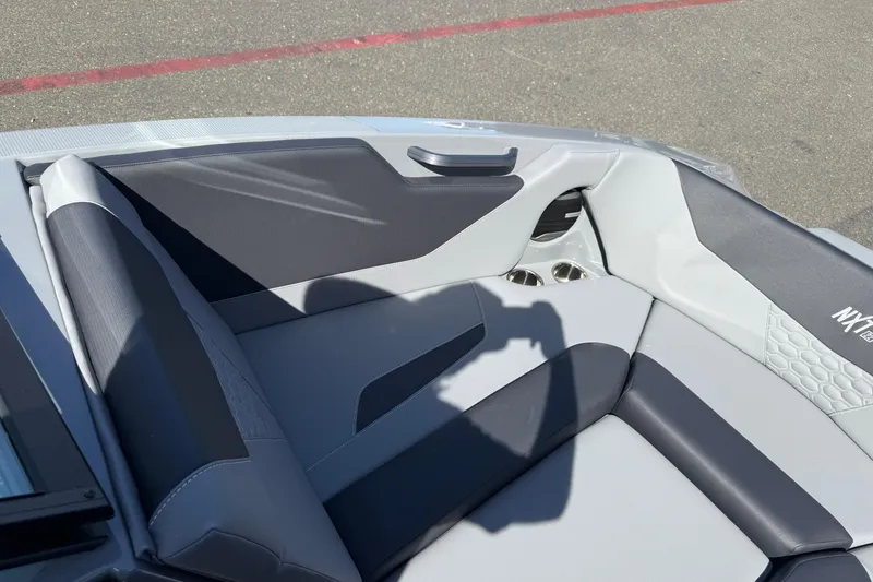 Slide: The Image of 2026 MasterCraft NXT22 boat interior with sleek gray seating and modern design. - 25