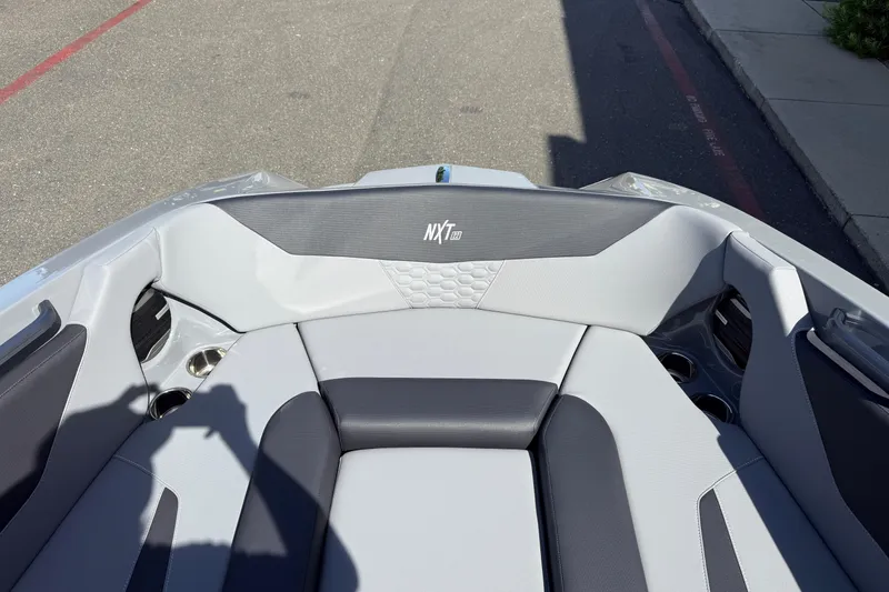 Slide: The Image of 2026 MasterCraft NXT22 boat interior with sleek gray seating and cup holders. - 26