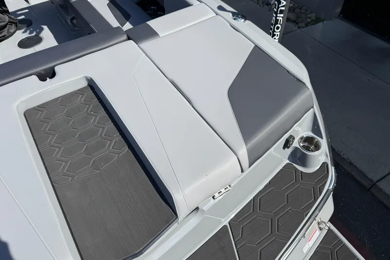 Slide: The Image of 2026 MasterCraft NXT22 boat interior with sleek seating and textured flooring design. - 29