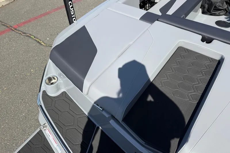 Slide: The Image of 2026 MasterCraft NXT22 boat interior with sleek gray seating and textured flooring. - 30