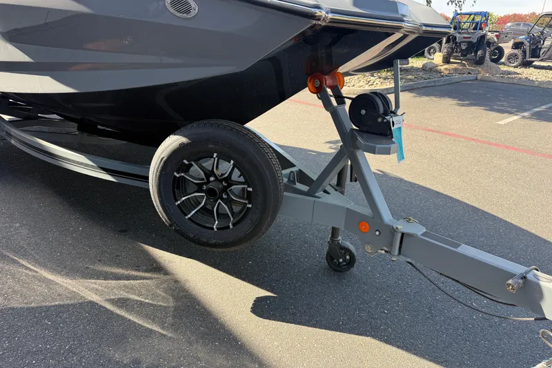 Slide: The Image of Trailer of a 2026 MasterCraft NXT22 boat parked on asphalt. - 8