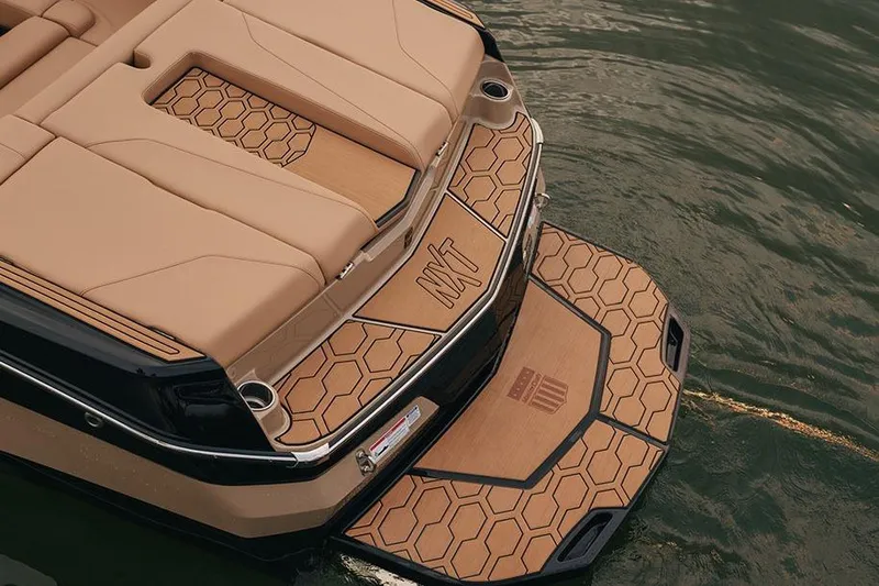 Slide: The Image of Manufacturer Provided Image: 2026 MasterCraft NXT20 boat with tan hexagonal pattern deck on water. - 6