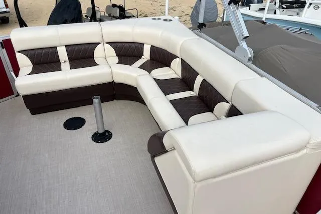 Slide: The Image of Luxurious seating on 2022 Lexington HP320 boat, featuring cream and brown upholstery. - 2