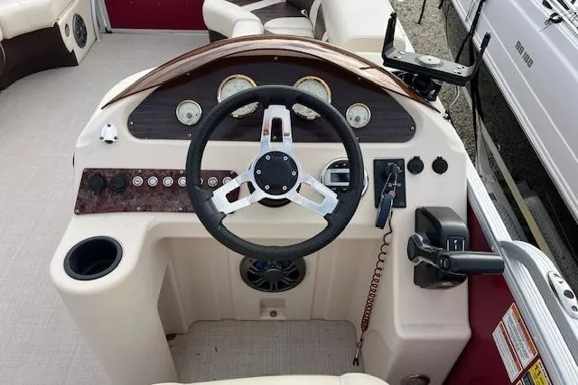 Slide: The Image of 2022 Lexington HP320 boat dashboard with steering wheel and control panel. - 4