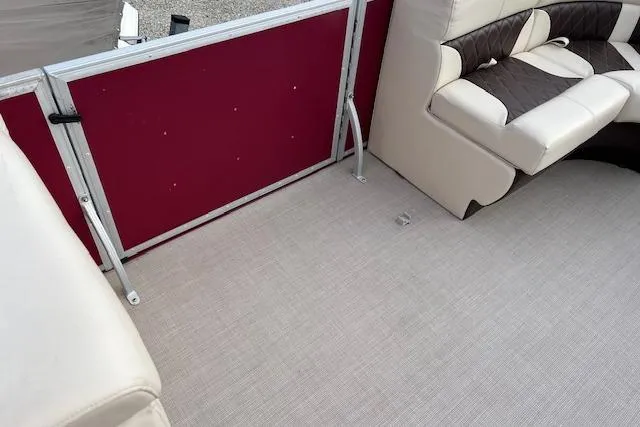 Slide: The Image of Interior of 2022 Lexington HP320 boat with beige seating and red paneling. - 8
