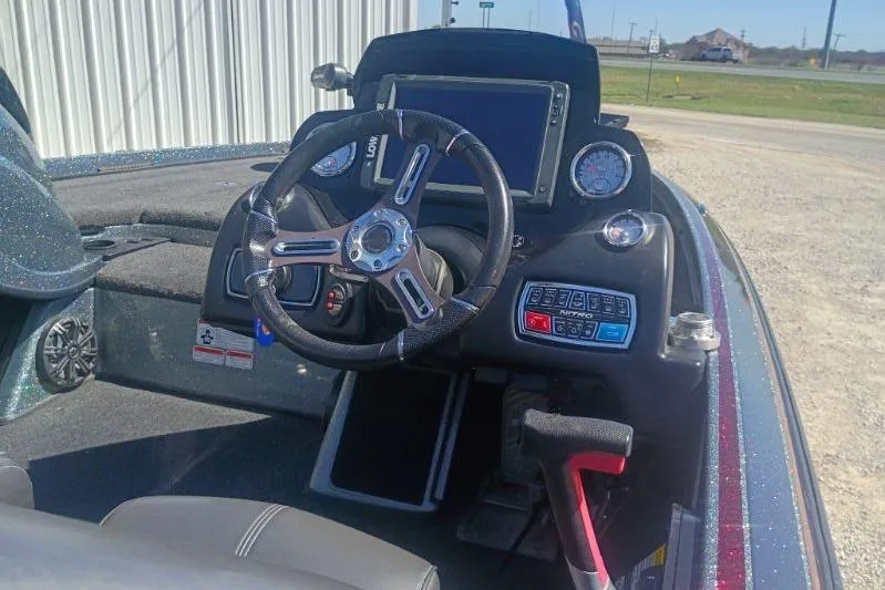Slide: The Image of Interior of a 2048 Nitro Z21 Pro boat with steering wheel and dashboard controls. - 5