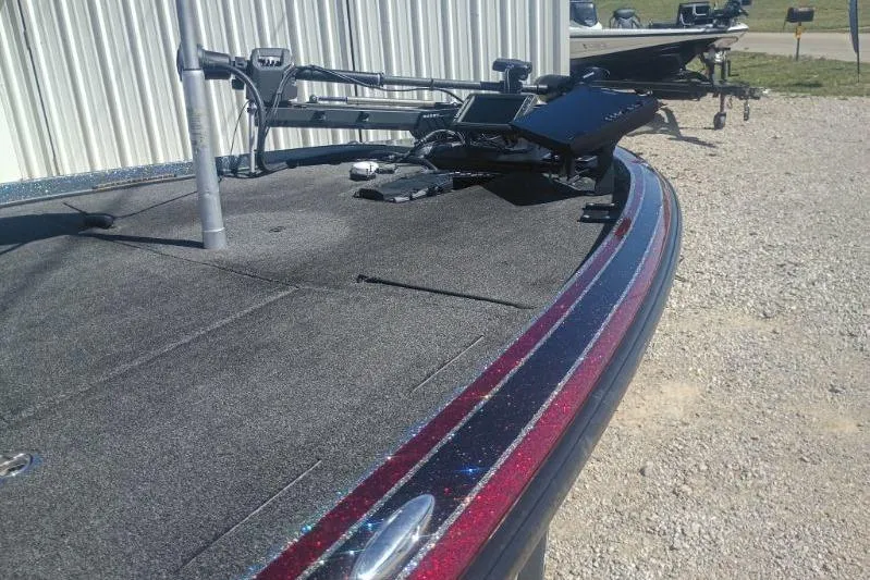 Slide: The Image of Nitro Z21 Pro 2048 boat deck with fishing equipment, parked on gravel. - 6