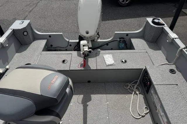 Slide: The Image of 2020 Alumacraft Summit 180 boat interior with seating and motor, showcasing storage and equipment. - 11