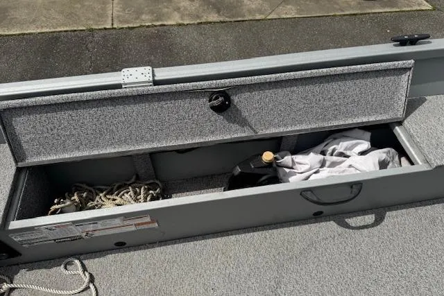 Slide: The Image of Storage compartment of 2020 Alumacraft Summit 180 boat with ropes and gear. - 12
