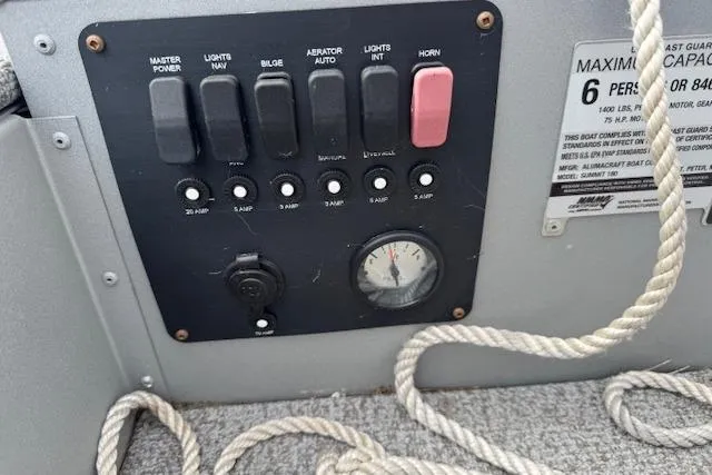Slide: The Image of Control panel of 2020 Alumacraft Summit 180 boat with switches and capacity label. - 19