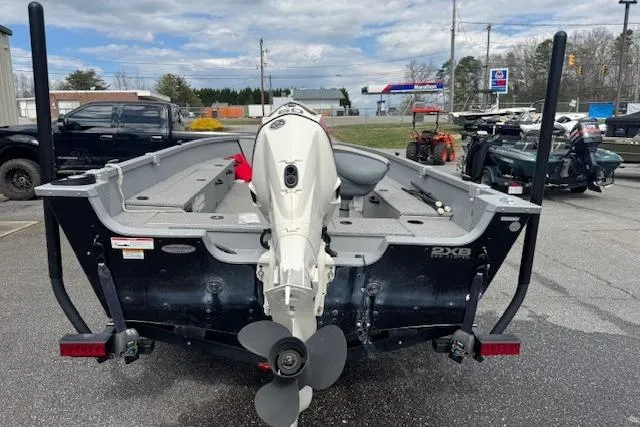 Slide: The Image of 2020 Alumacraft Summit 180 boat with outboard motor, parked in a lot. - 5