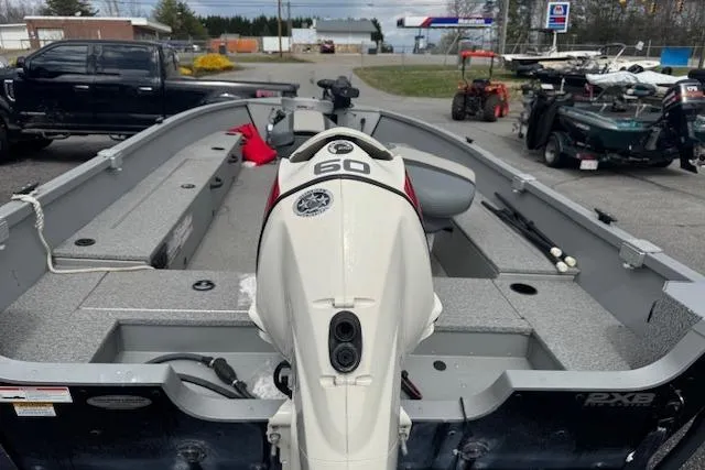 Slide: The Image of 2020 Alumacraft Summit 180 boat with a 60 HP outboard motor, parked outdoors. - 6