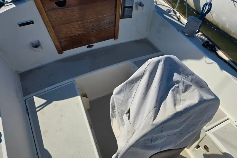 Slide: The Image of Cockpit of 1985 O'Day 31 sailboat with covered helm and wooden hatch. - 10