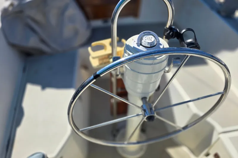 Slide: The Image of Steering wheel of a 1985 O'Day 31 sailboat, featuring a Ritchie compass. - 15
