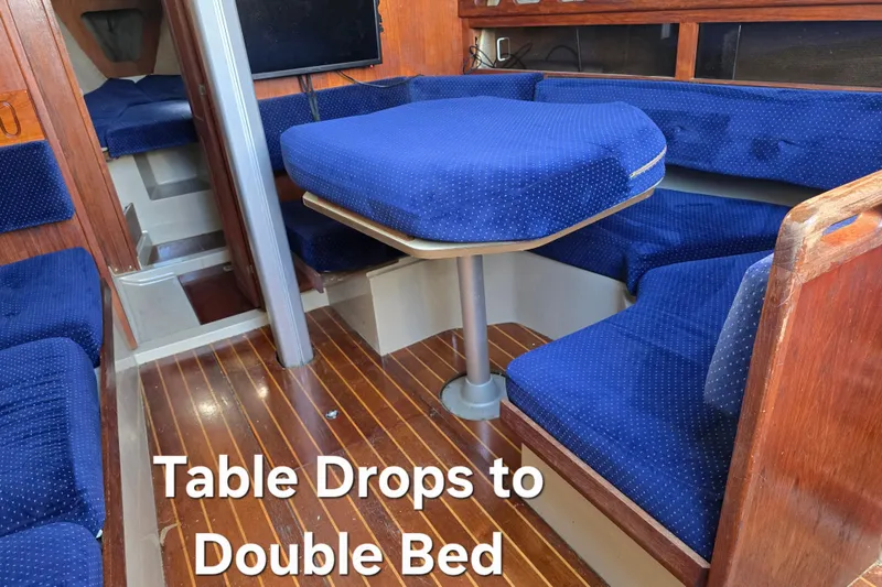 Slide: The Image of Interior of 1985 O'Day 31 sailboat with convertible table and blue seating. - 25
