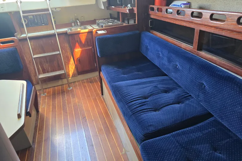 Slide: The Image of Interior of 1985 O'Day 31 sailboat with blue upholstery and wooden cabinetry. - 30