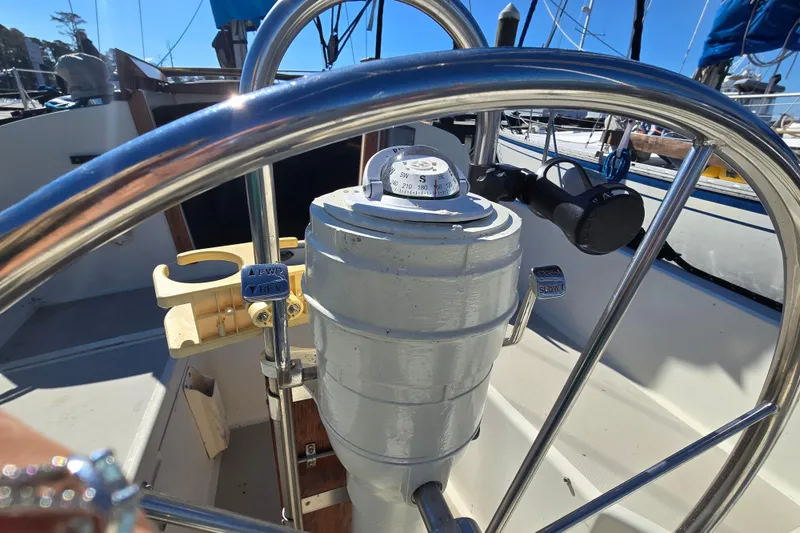 Slide: The Image of 1985 O'Day 31 sailboat cockpit with steering wheel and navigation instruments. - 33