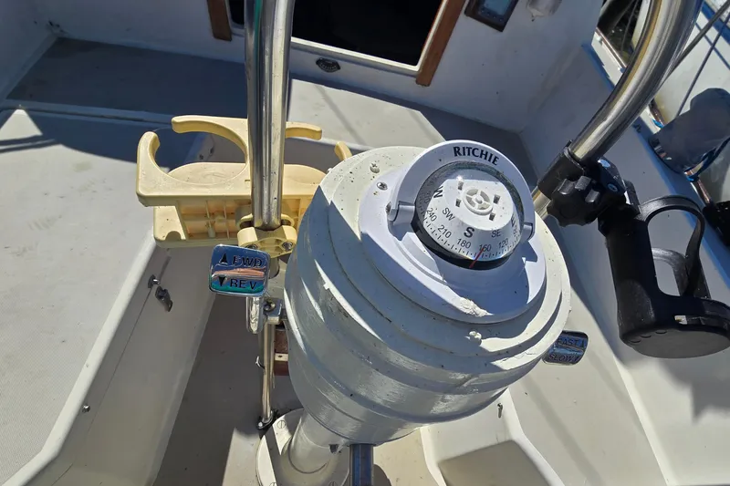 Slide: The Image of Cockpit of 1985 O'Day 31 sailboat with Ritchie compass and throttle controls. - 34