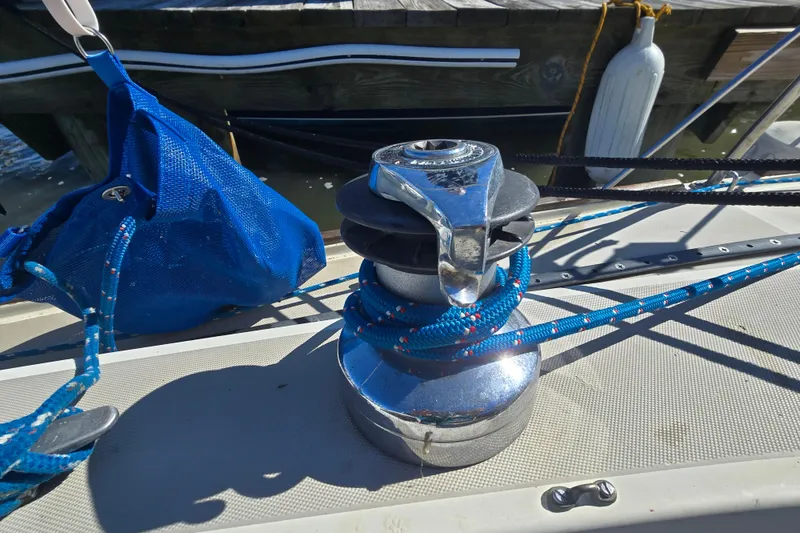 Slide: The Image of Winch on 1985 O'Day 31 sailboat with blue rope and dock background. - 35