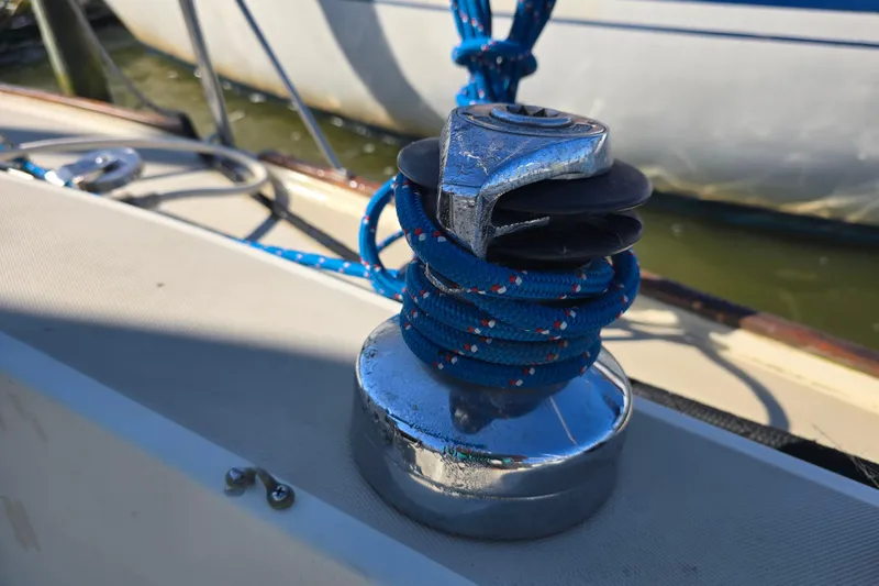 Slide: The Image of Winch with blue rope on 1985 O'Day 31 sailboat deck. - 36
