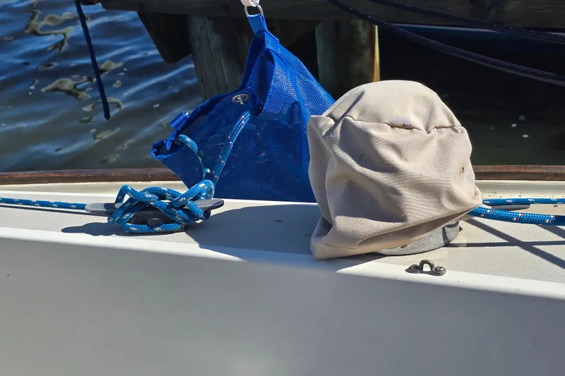 Slide: The Image of 1985 O'Day 31 sailboat deck with blue rope and canvas cover. - 38