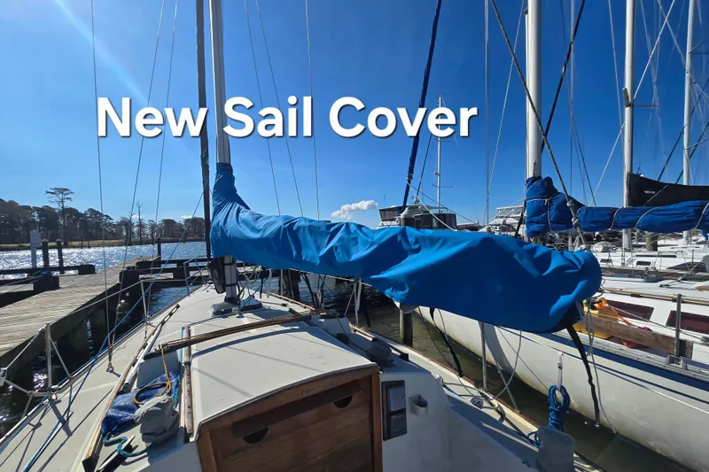 Slide: The Image of 1985 O'Day 31 sailboat with new blue sail cover at marina. - 4