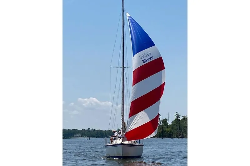 Slide: The Image of 1985 O'Day 31 sailboat with colorful spinnaker on a sunny day. - 7
