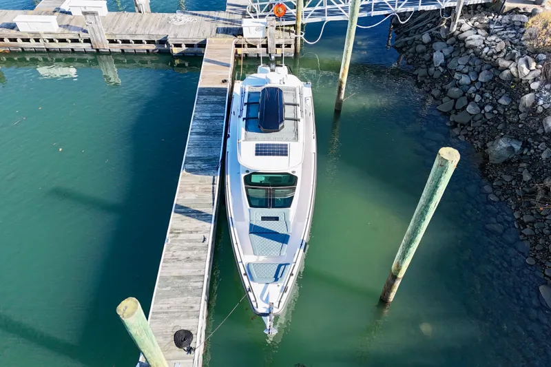 Slide: The Image of 2023 Axopar 37 Cross Cabin docked at a marina, aerial view. - 10