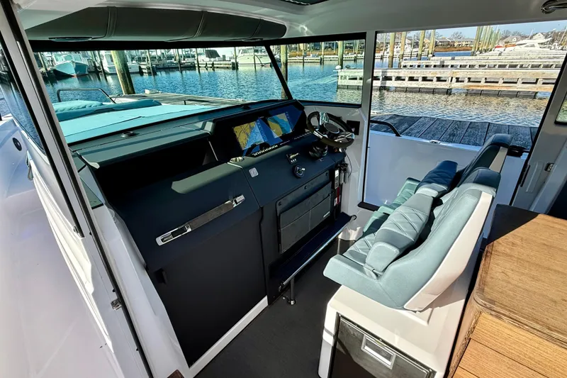 Slide: The Image of Interior of 2023 Axopar 37 Cross Cabin boat with helm and seating. - 27