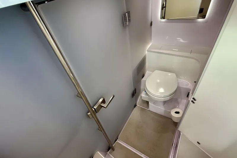 Slide: The Image of 2023 Axopar 37 Cross Cabin bathroom with modern fixtures and compact design. - 29