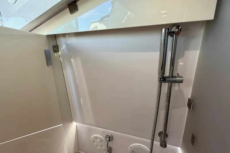 Slide: The Image of Interior shower area of 2023 Axopar 37 Cross Cabin boat, featuring sleek design and modern fixtures. - 31