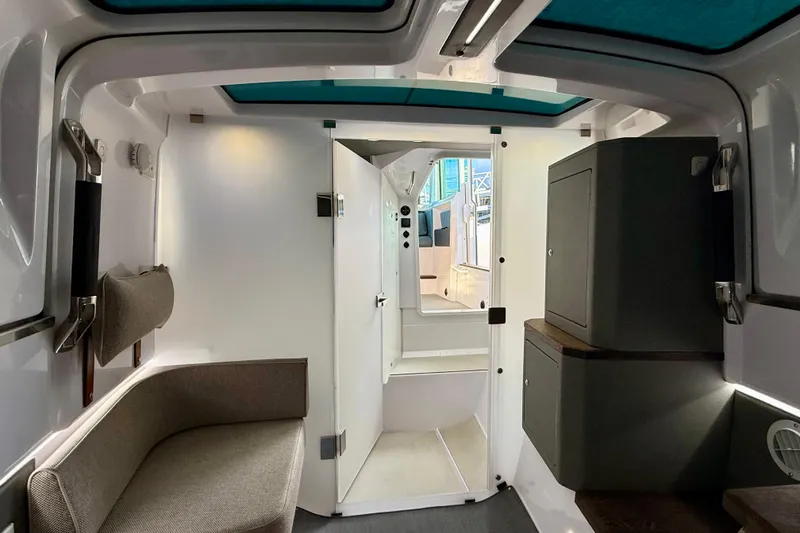 Slide: The Image of Interior of 2023 Axopar 37 Cross Cabin, featuring modern seating and storage. - 32