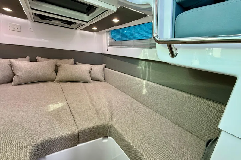 Slide: The Image of Luxurious interior cabin of 2023 Axopar 37 Cross Cabin with comfortable bedding and cushions. - 38