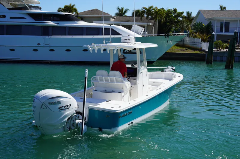 Slide: The Image of 2024 Regulator 26XO boat with Yamaha engine on turquoise water. - 16