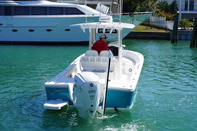 Slide: The Image of 2024 Regulator 26XO boat with Yamaha 450 V8 engine on turquoise water. - 18