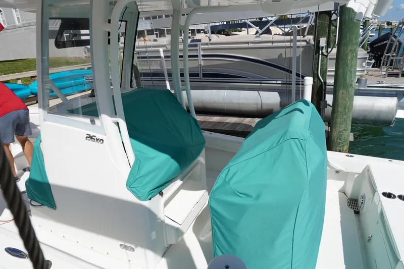 Slide: The Image of 2024 Regulator 26XO boat with teal covers docked at marina. - 32