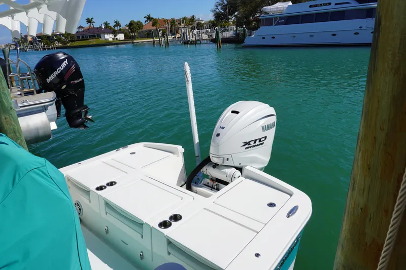 Slide: The Image of 2024 Regulator 26XO boat with Yamaha and Mercury outboard engines docked in marina. - 33