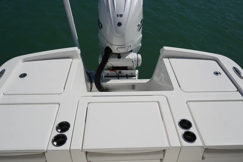 Slide: The Image of 2024 Regulator 26XO boat stern with outboard motor and storage compartments. - 34