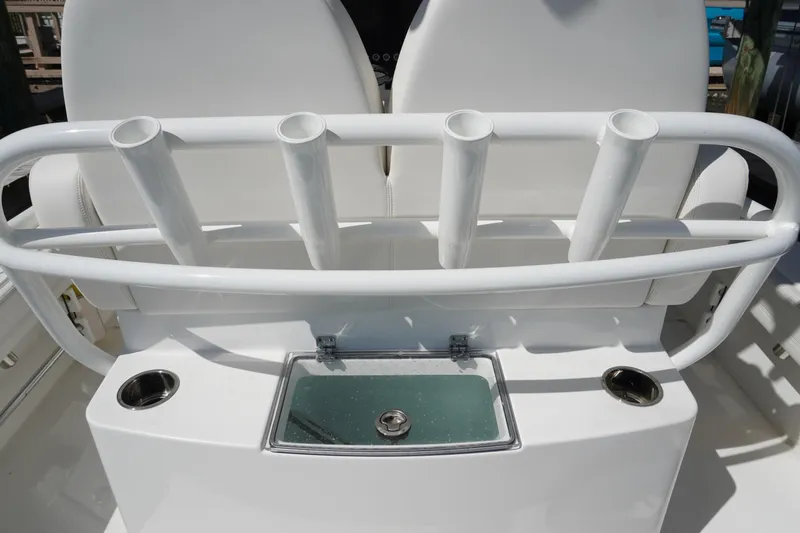 Slide: The Image of 2024 Regulator 26XO boat with rod holders and livewell, showcasing sleek design. - 36
