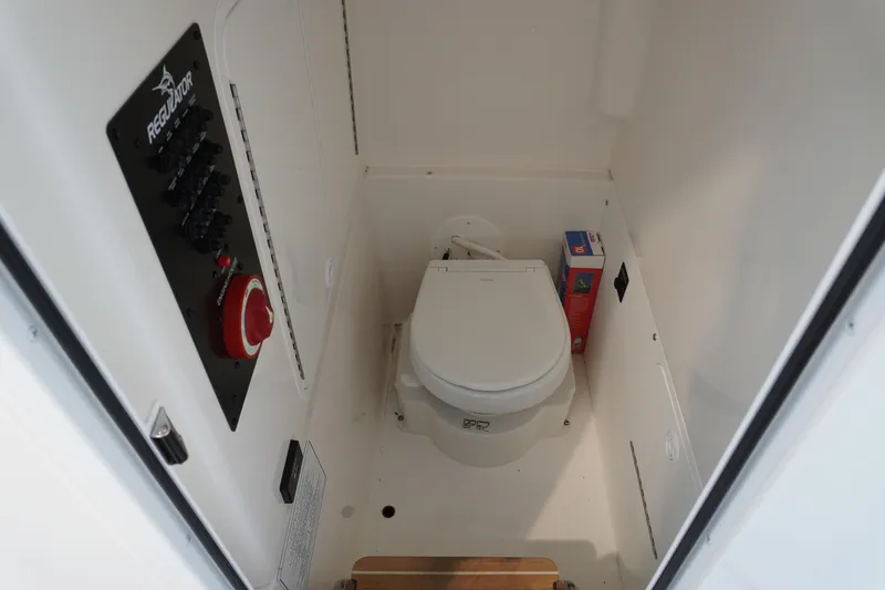 Slide: The Image of 2024 Regulator 26XO boat interior with toilet and control panel. - 40