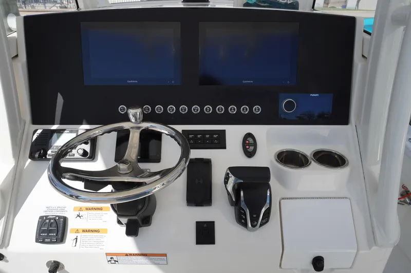 Slide: The Image of 2024 Regulator 26XO boat dashboard with dual screens and steering wheel. - 41